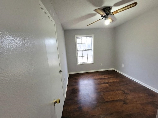 spare room featuring dark hardwood / wood-style floors and ceiling fan