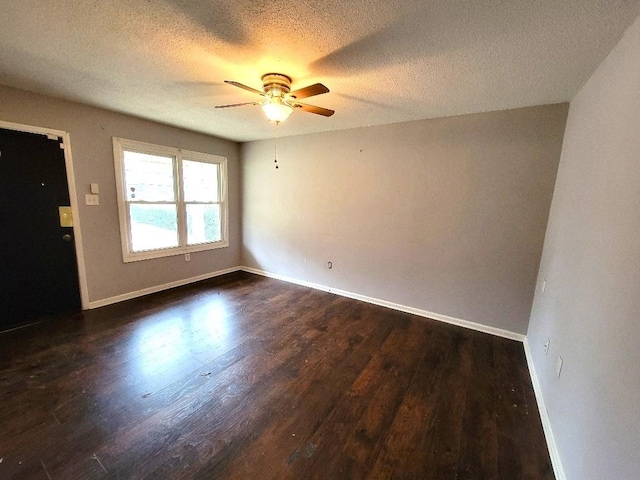 empty room featuring a textured ceiling, dark hardwood / wood-style flooring, and ceiling fan