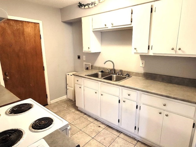 kitchen with white cabinets, light tile patterned floors, white electric stove, and sink