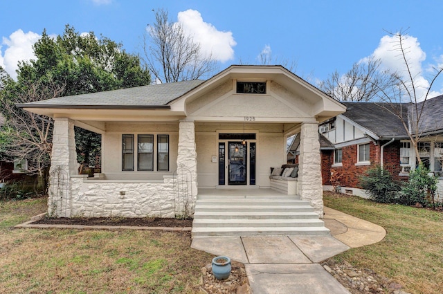 view of front of home featuring a front yard and a porch