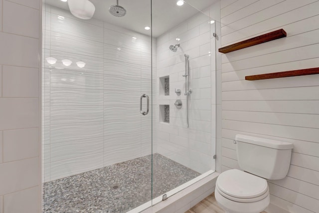 bathroom featuring an enclosed shower and toilet