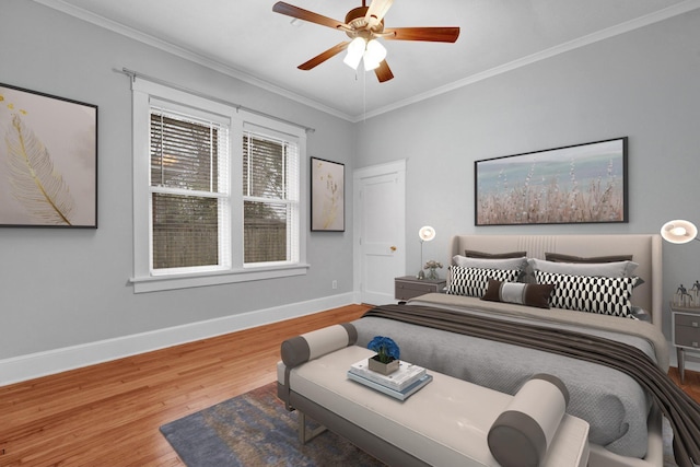 bedroom with ceiling fan, hardwood / wood-style floors, and ornamental molding