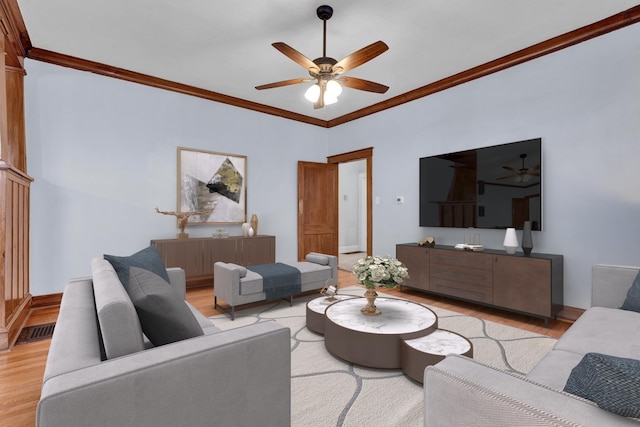 living room with light hardwood / wood-style flooring and ornamental molding