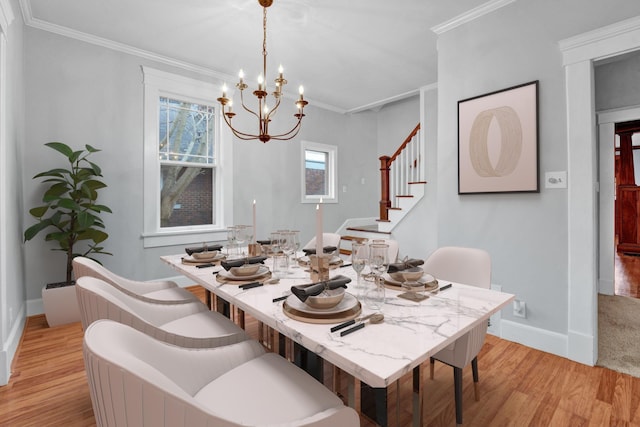 dining area featuring a chandelier, light hardwood / wood-style floors, and ornamental molding