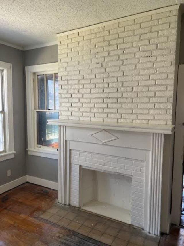 details featuring a fireplace, hardwood / wood-style floors, and a textured ceiling