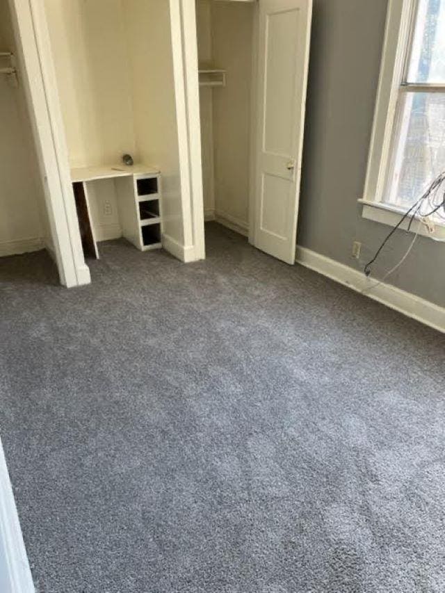 unfurnished bedroom featuring dark colored carpet