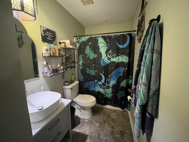 full bathroom with vanity, a shower with shower curtain, toilet, and visible vents