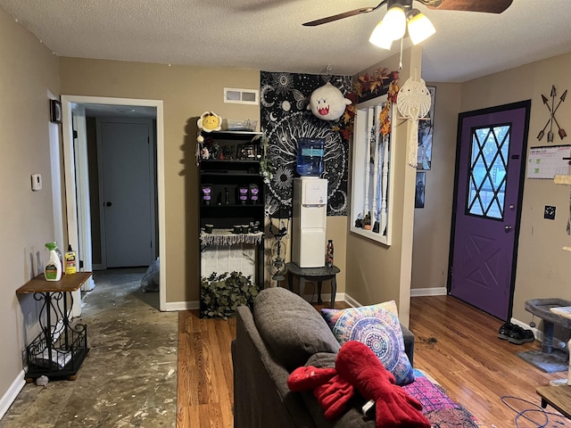 foyer featuring a textured ceiling and ceiling fan