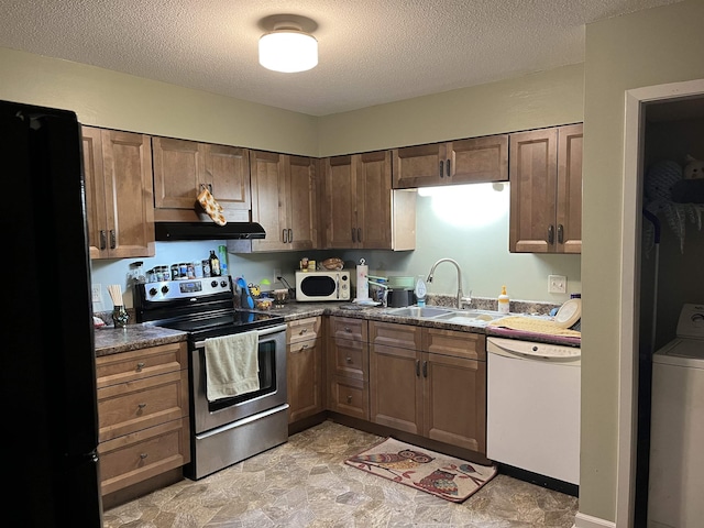 kitchen featuring dishwasher, stainless steel electric range oven, freestanding refrigerator, washer / clothes dryer, and a sink