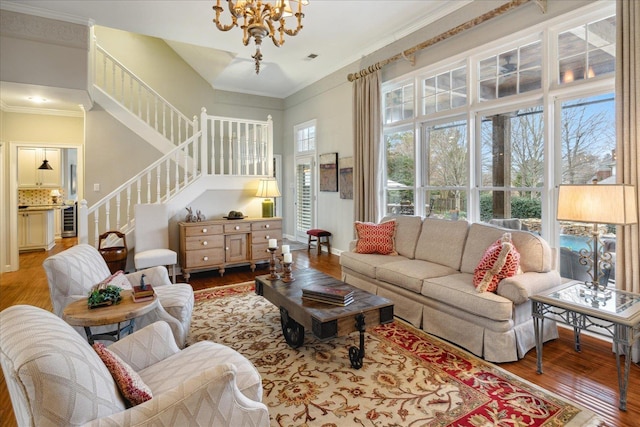 living room with a chandelier, hardwood / wood-style floors, plenty of natural light, and beverage cooler