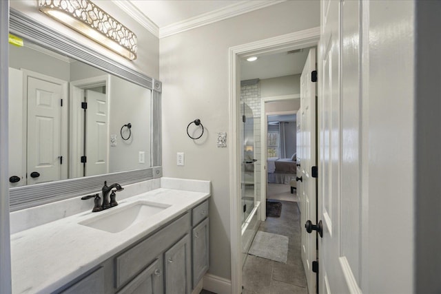 bathroom with crown molding, tile patterned flooring, and vanity