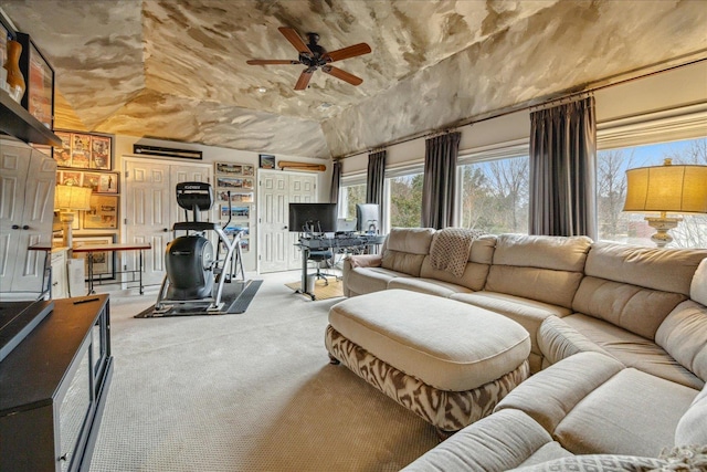 carpeted living room featuring ceiling fan and lofted ceiling