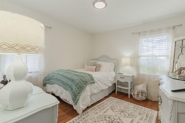 bedroom with dark hardwood / wood-style flooring