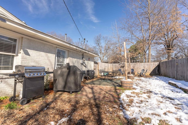 snowy yard featuring a patio