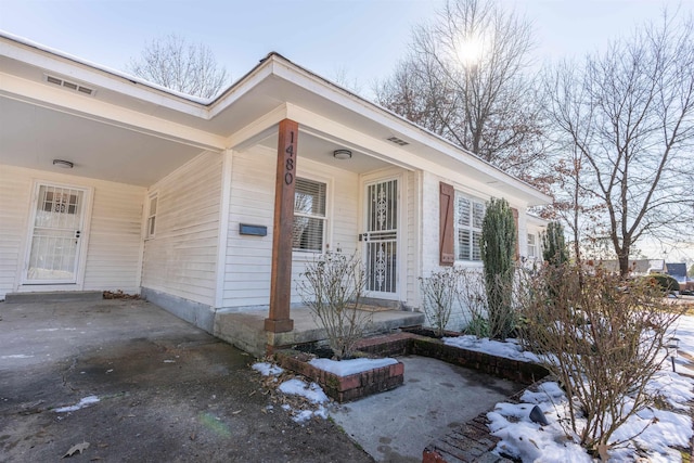 view of snow covered property entrance