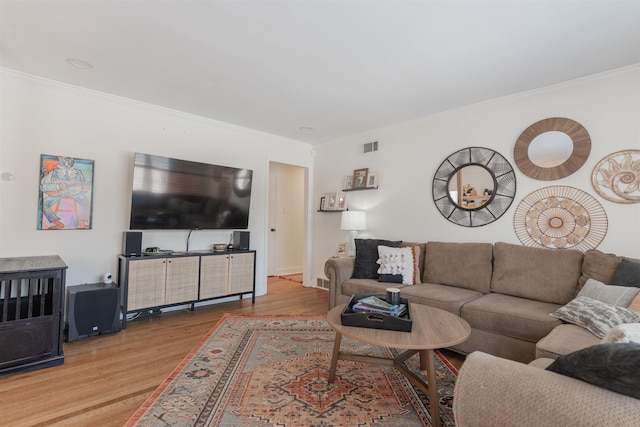 living room featuring light hardwood / wood-style flooring and crown molding