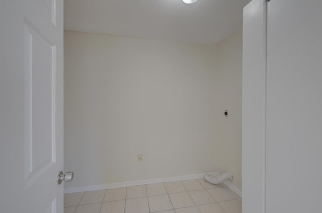 tiled spare room featuring a textured ceiling