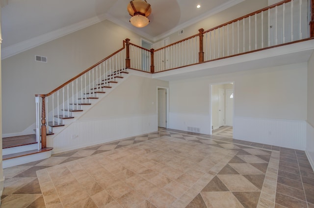 unfurnished living room featuring a high ceiling and ornamental molding