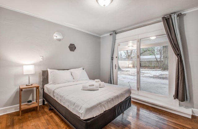 bedroom with access to outside, hardwood / wood-style flooring, and ornamental molding