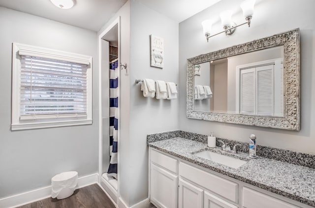 bathroom featuring vanity, hardwood / wood-style flooring, and curtained shower