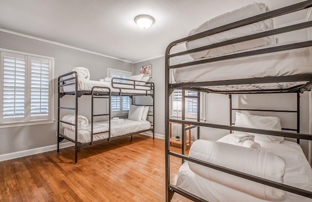 bedroom with ornamental molding and hardwood / wood-style flooring