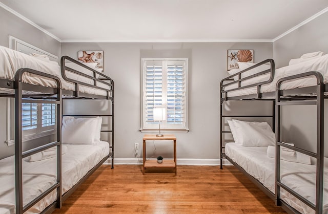 bedroom featuring hardwood / wood-style floors and crown molding