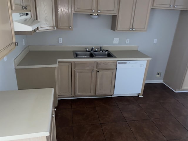 kitchen featuring dark tile patterned flooring, dishwasher, and sink