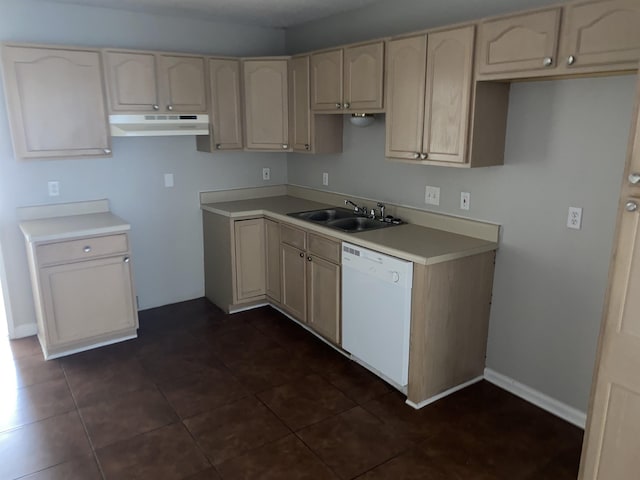 kitchen featuring dishwasher, dark tile patterned floors, and sink