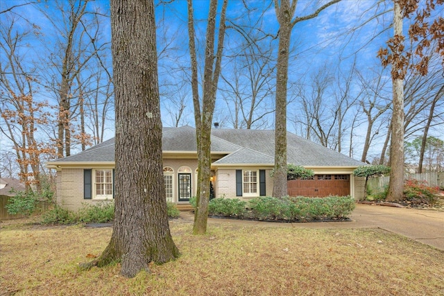 single story home with a front yard and a garage