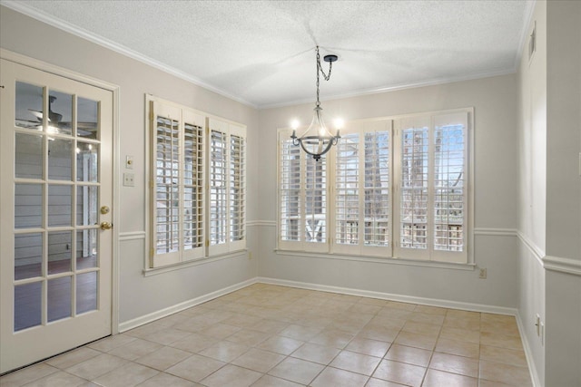 unfurnished dining area with a chandelier, light tile patterned floors, a textured ceiling, and ornamental molding