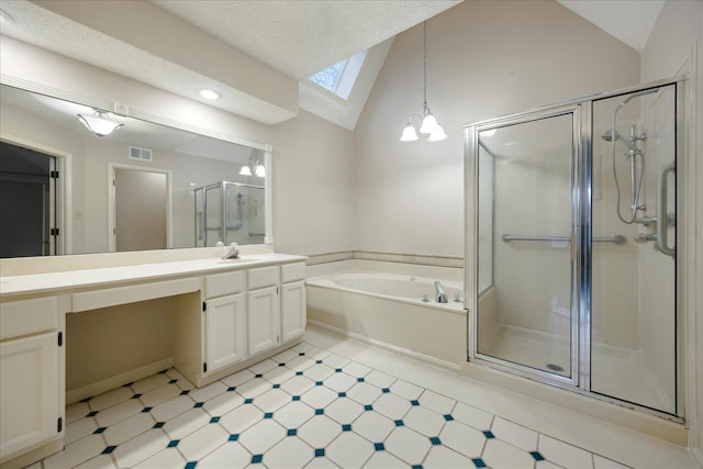 bathroom featuring plus walk in shower, vaulted ceiling with skylight, vanity, and a notable chandelier