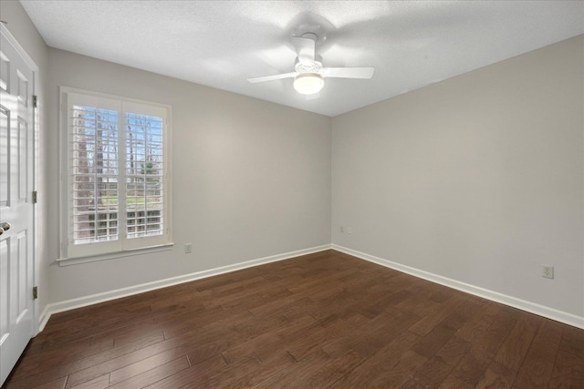 empty room featuring a textured ceiling, ceiling fan, and dark wood-type flooring