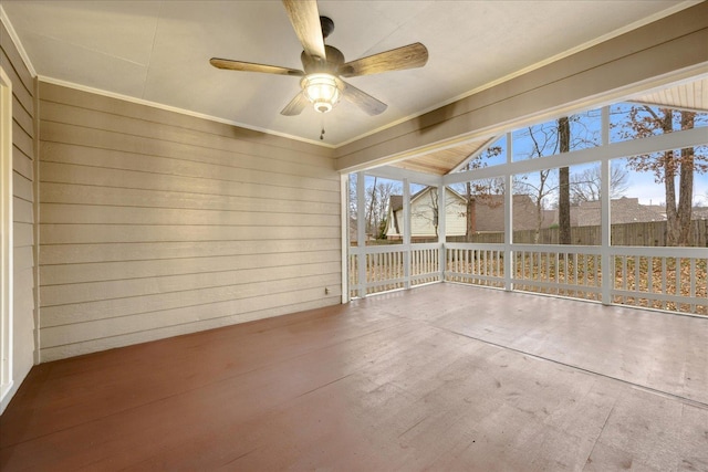 unfurnished sunroom with ceiling fan