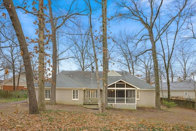 rear view of property with a sunroom