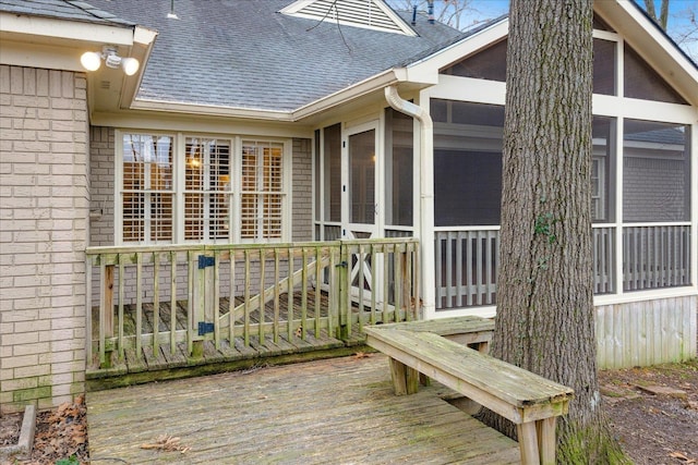 wooden deck with a sunroom