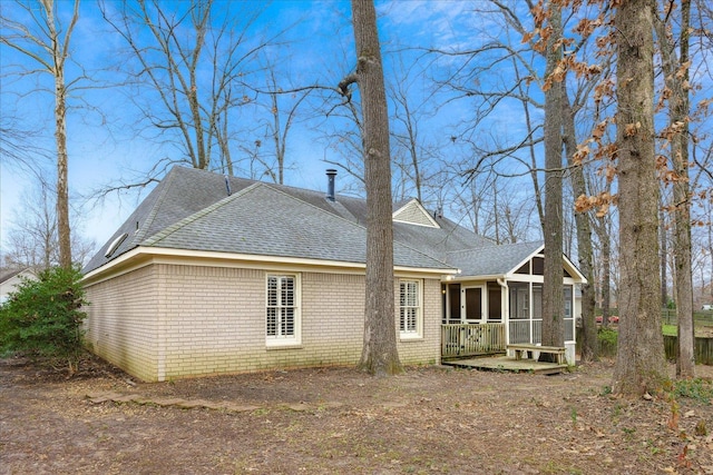 view of side of property with a sunroom