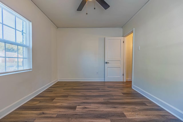 empty room featuring dark hardwood / wood-style floors, ceiling fan, and a healthy amount of sunlight