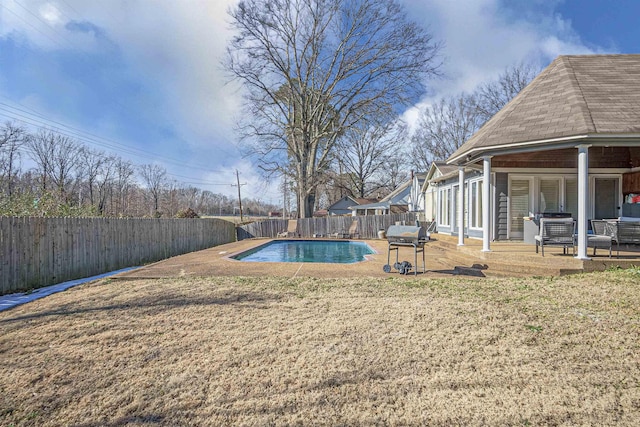 view of pool with a yard