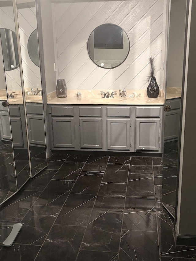 bathroom featuring wood walls and vanity