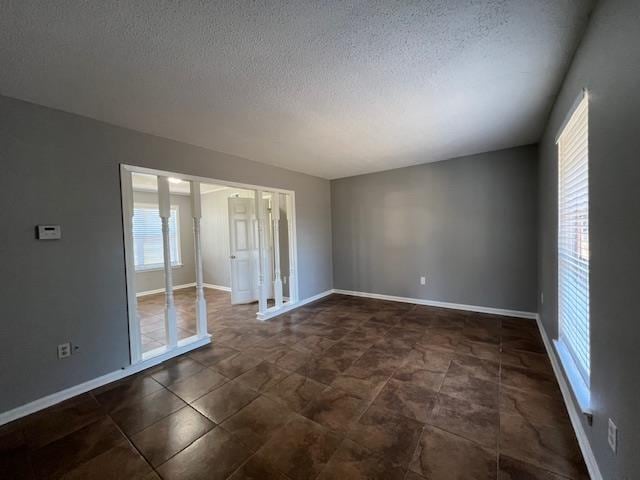 spare room with a textured ceiling