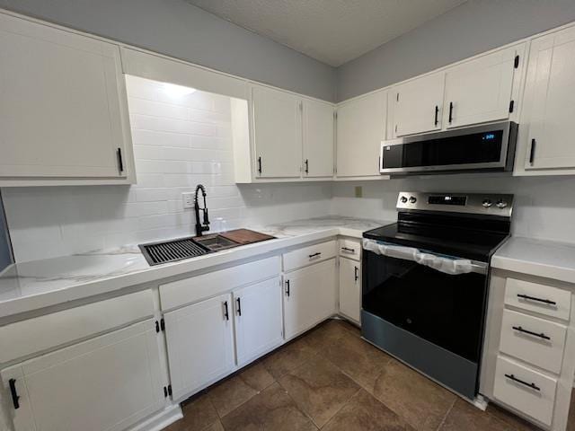 kitchen with white cabinets, sink, and appliances with stainless steel finishes