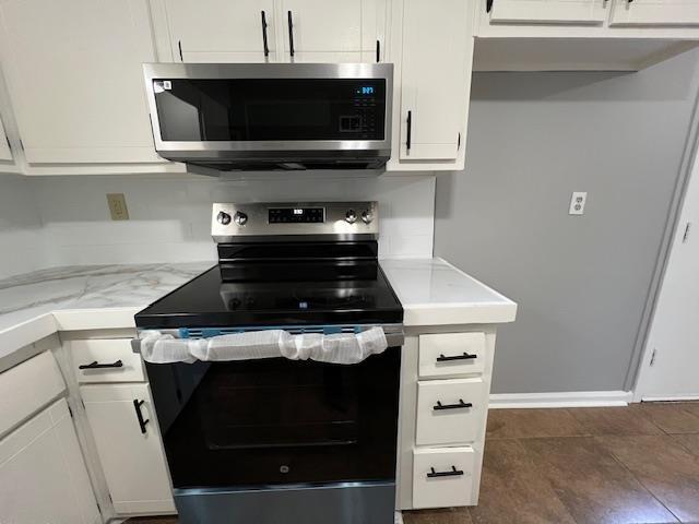 kitchen featuring white cabinetry and appliances with stainless steel finishes