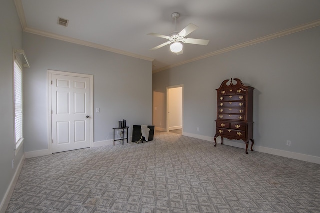 spare room with crown molding, ceiling fan, and a healthy amount of sunlight