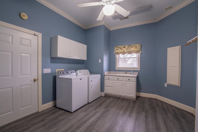 washroom featuring ceiling fan, dark wood-type flooring, cabinets, independent washer and dryer, and ornamental molding