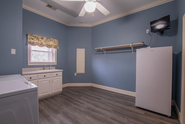 laundry room featuring cabinets, dark hardwood / wood-style floors, ornamental molding, and sink