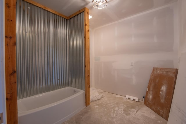 bathroom with a tub and concrete floors