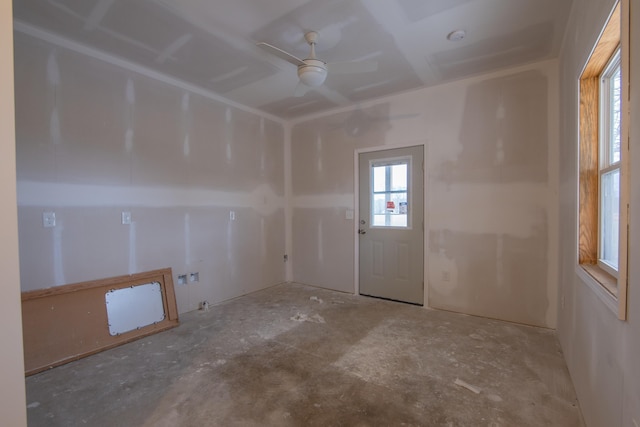 empty room with ceiling fan and concrete floors