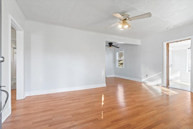 empty room featuring a textured ceiling, light wood-type flooring, ceiling fan, and ornamental molding