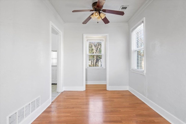 spare room with crown molding, light hardwood / wood-style flooring, and ceiling fan