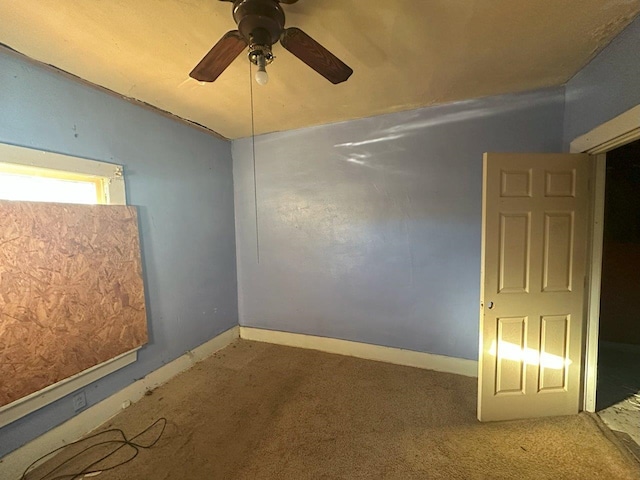 empty room featuring carpet flooring and ceiling fan